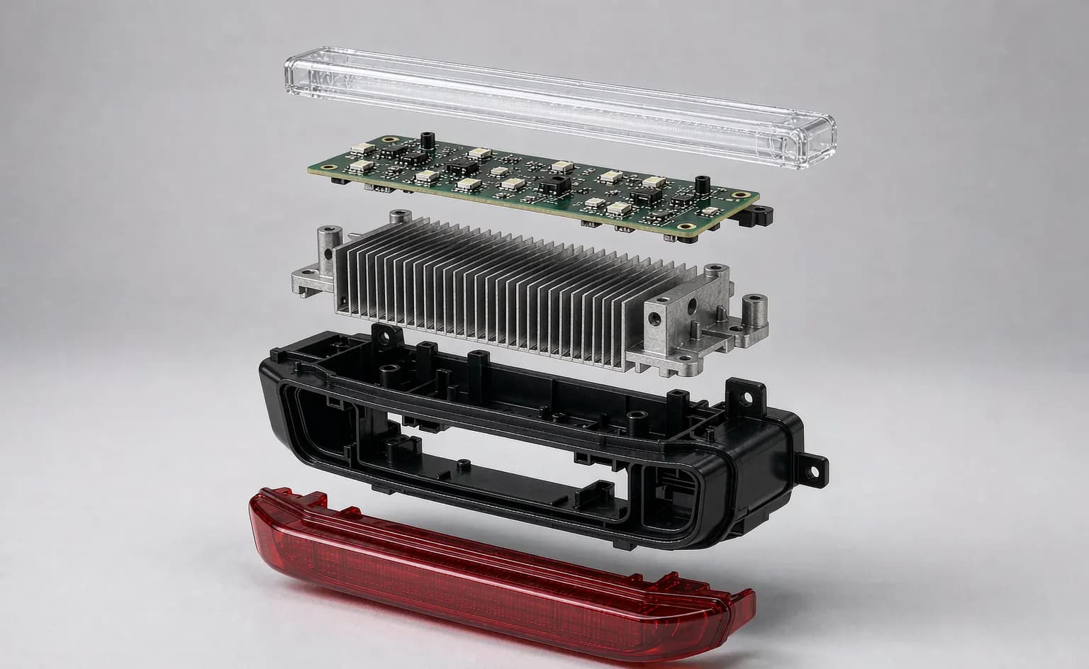 Exploded view of an LED rear bumper light assembly showing lens, light guide, LED board, heat sink and housing